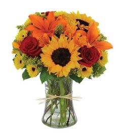 a vase filled with orange and yellow flowers