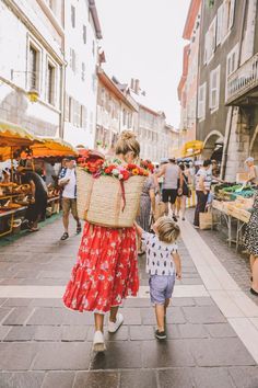 a woman and child walking down a street