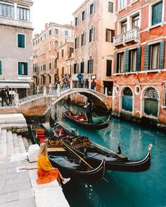 two gondolas are tied to the side of a bridge in venice, italy