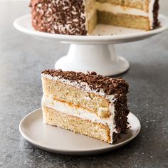 two layers of cake on a plate with one slice cut out and the other half eaten