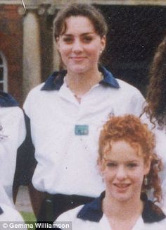 a group of young women standing next to each other in front of a brick building