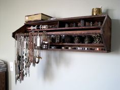 an old wooden shelf with jewelry hanging from it