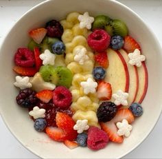 a white bowl filled with fruit and cereal