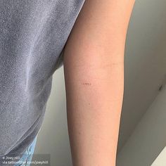 a person with a small tattoo on their arm