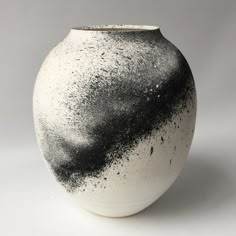 a black and white vase sitting on top of a table