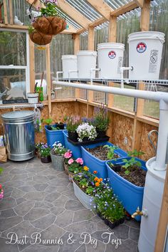 a greenhouse filled with lots of potted plants