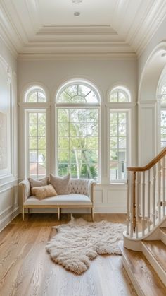 a living room filled with furniture and lots of windows