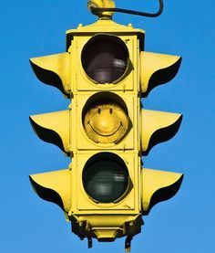 a traffic light with a smiley face painted on it