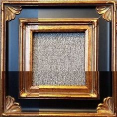 an old gold frame with some black and white stripes on it's sides, in front of a blue wall