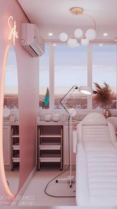 a white couch sitting in front of a window next to a desk with a laptop on it