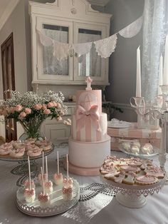 a table topped with lots of cakes and cupcakes