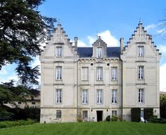 a large building sitting on top of a lush green field