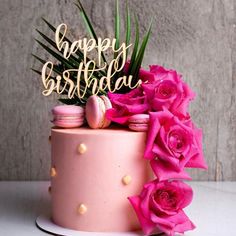 a birthday cake with pink flowers and a happy birthday sign