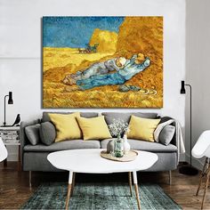 a living room filled with furniture and a painting on the wall