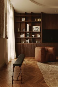 a living room filled with furniture and bookshelves