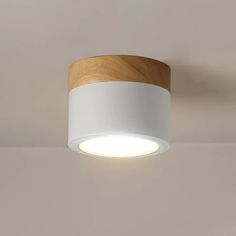 a white and wooden light hanging from the ceiling