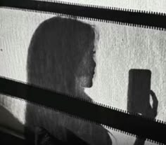 the shadow of a woman holding a coffee mug