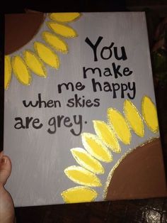 someone is holding up a sign that says you make me happy when skies are grey