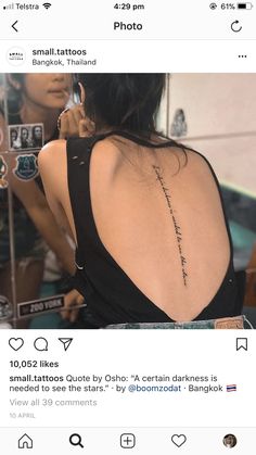 the back of a woman's neck with an inscription on her left shoulder and right arm