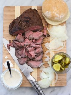 a cutting board topped with meat and vegetables