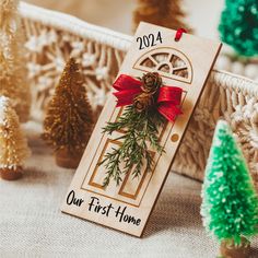 a wooden door with a red bow on it next to christmas trees and other decorations