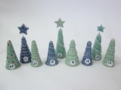 a group of ceramic christmas trees sitting next to each other