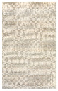 a beige and white rug with an intricate design on the bottom, in front of a white background