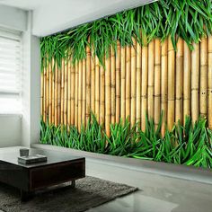 a living room with a large bamboo wall mural on it's side and a coffee table in front of it