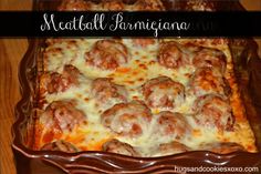 a casserole dish filled with meatballs and cheese