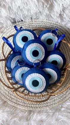 blue evil eye keychains in a woven basket on a white furnishing