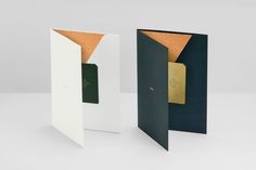 two folded cards with gold foil on them