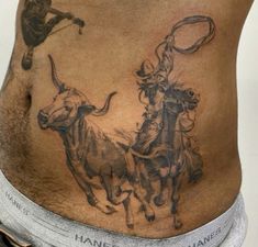 a man with tattoos on his stomach has two bulls in the shape of an arrow