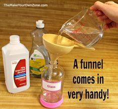 a person pours liquid into a measuring cup from a funnell to make a homemade hand sanitizer