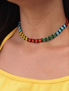 a woman wearing a colorful beaded necklace