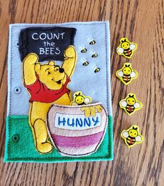 a winnie the pooh book with bees on it and some stickers next to it