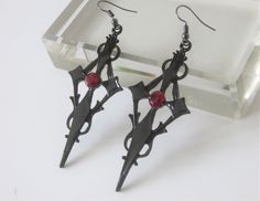 Black earrings, cross. Gothic style, punk, manga. Black metal cross with red rhinestones in the center. Width 3.3 cm x height 7 cm + hooks Black Metal Cross Earrings, Black Cross Metal Earrings, Black Gothic Cross Earrings, Goth Staples, Cross Gothic, Earrings Cross, Metal Cross, Style Punk, Red Rhinestone