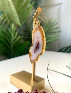 These stylish agate earrings feature a unique contrast between golden orange, milky white, and maroon. The stones are 24k gold edged and will add a striking pop of color to your outfit! 2 1/2'' Long 14k Gold-filled Earring Hooks Gold Agate Gemstone Earrings, Gold Agate Drop Earrings, Gold Agate Earrings With Natural Stones, Gold Earrings With Natural Agate Stones, Gold Agate Earrings, Handmade Gold Agate Earrings, Orange Agate, Agate Earrings, Milky White