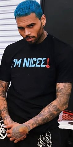 a man with blue hair wearing a t - shirt that says i'm nice