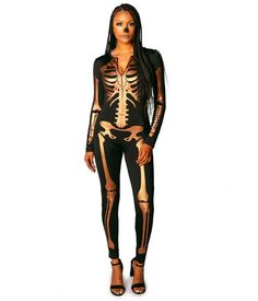 a woman in skeleton print bodysuit and heels posing for the camera with her hands on her hips