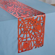 an orange table runner on top of a blue table