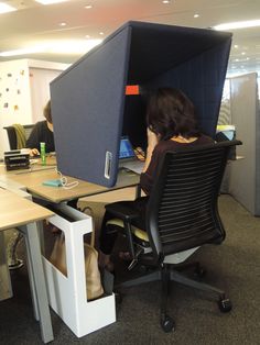 a woman sitting in an office chair with her back to the camera