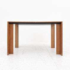 a wooden table sitting on top of a white floor