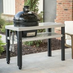 an outdoor bbq grill sitting on top of a table