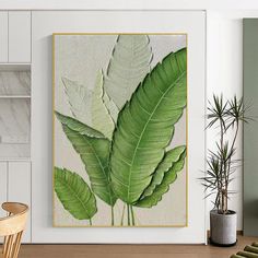 there is a large green leaf on the wall in this living room with white walls