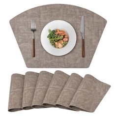 the placemats are laid out next to a plate with food and silverware on it