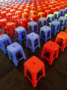 rows of plastic stools sitting on the ground