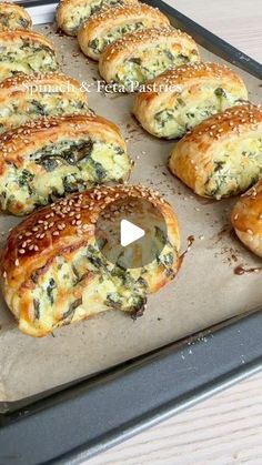 there are many bagels that have been baked on the baking sheet with sesame sprinkles