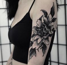 black and white flower tattoo on the left arm