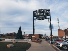 a christmas tree sits in front of the sign for johnson city