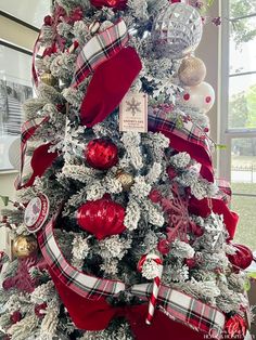 a christmas tree decorated with red, white and silver ornaments